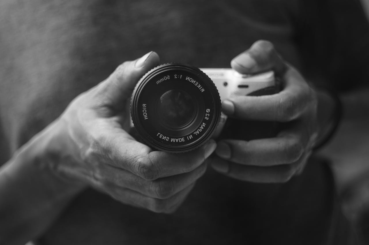 Home black-and-white-close-up-of-hands-holding-camera-33267145